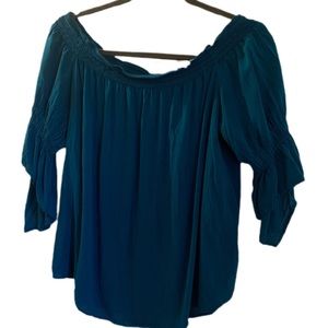 Off shoulder teal blouse with sleeves.